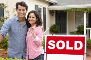 couple in front of sold home