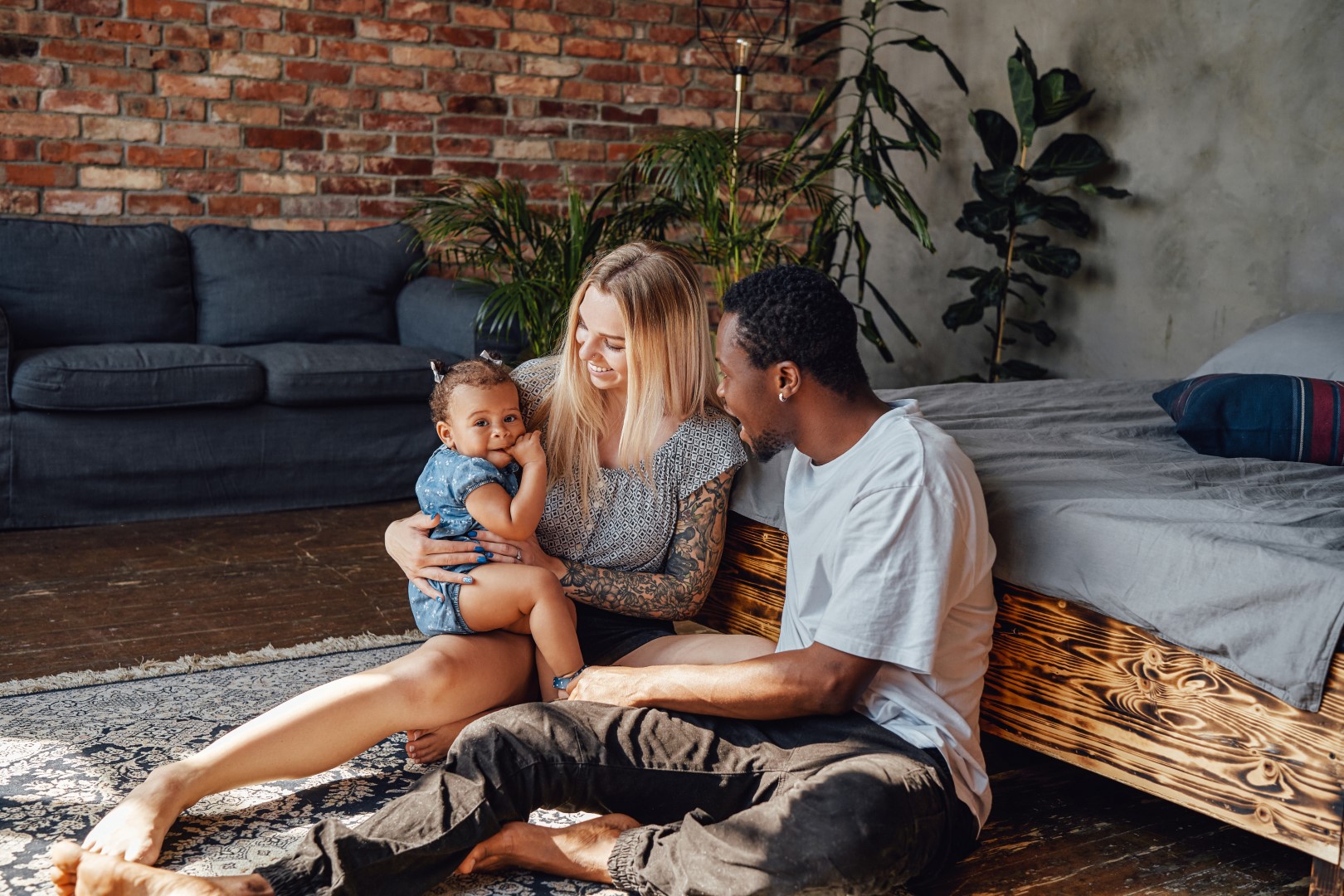 multi-ethnic family sitting on the floor in a living room