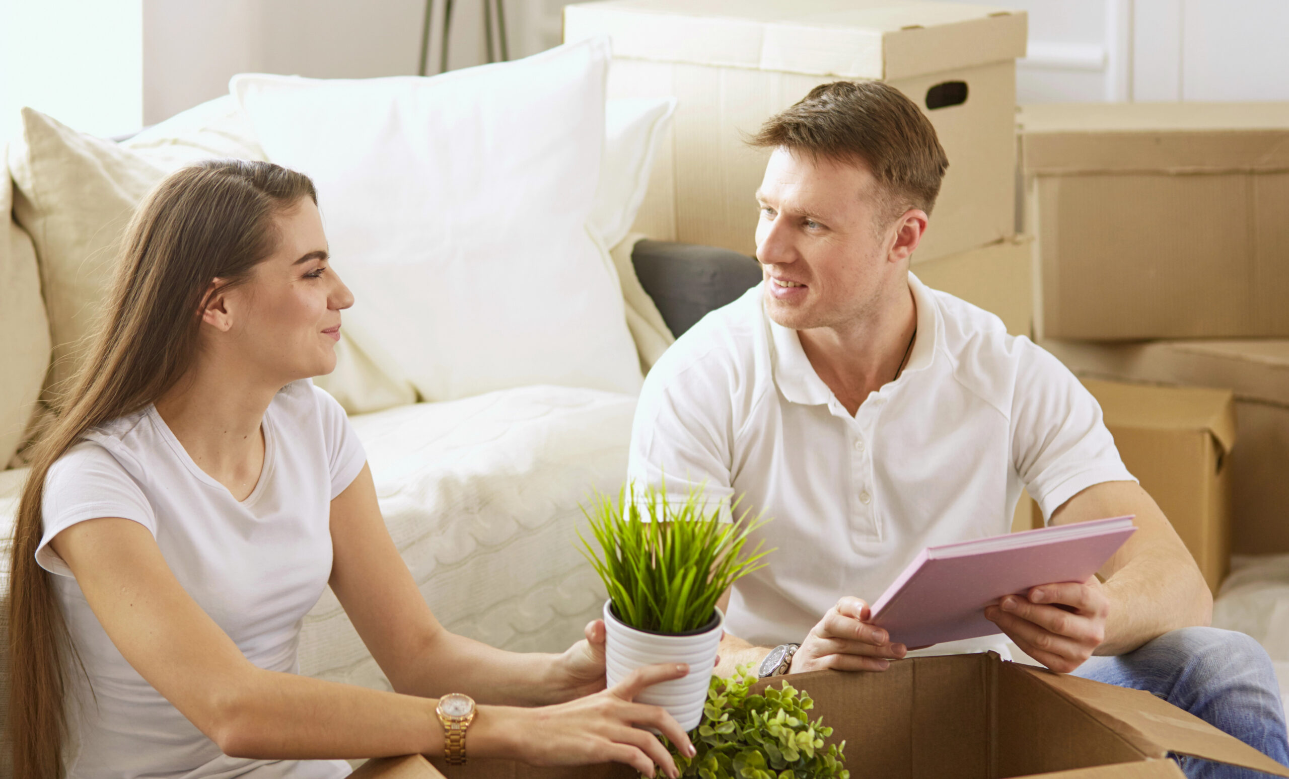 a smiling couple looking over a long distance moving quote
